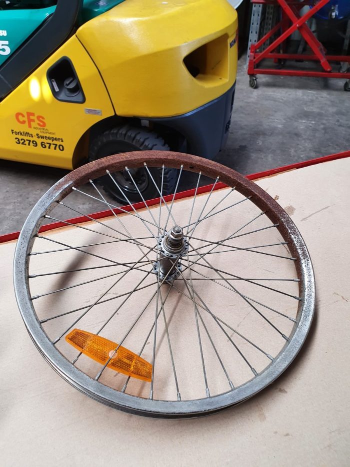 bicycle rim soaked in rust remover liquid